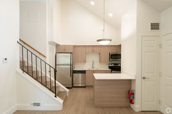 Kitchen with a refrigerator, oven, and sink